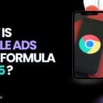 A digital marketing-themed image with the text 'What is Google Ads Rank Formula in 2025?' in bold, colorful fonts on a black background. To the right, there's a smartphone displaying the Google Chrome logo, and beside it, a woman in a purple outfit smiling while writing in a notebook, sitting next to a casually dressed person. The website URL www.zabtechdigital.ae is visible at the bottom left.